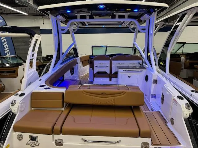 Slide: The Image of 2025 Chaparral 280 OSX boat interior with brown seating and modern design. - 20