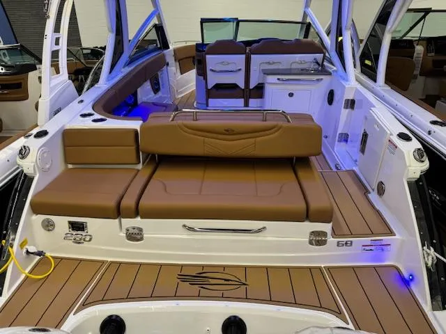 Slide: The Image of 2025 Chaparral 280 OSX boat interior with brown seating and modern design. - 21