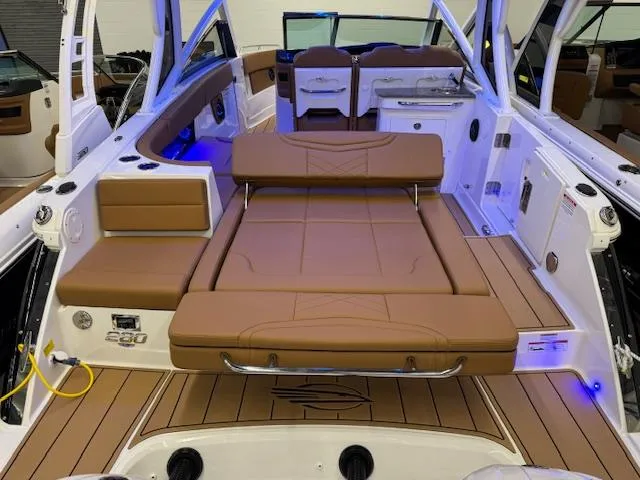 Slide: The Image of 2025 Chaparral 280 OSX boat interior with tan seating and modern design. - 22