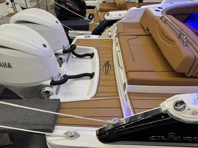 Slide: The Image of 2025 Chaparral 280 OSX boat with Yamaha engines and tan seating. - 23