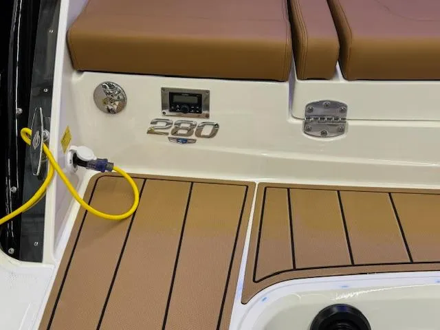Slide: The Image of 2025 Chaparral 280 OSX boat deck with brown seating and power connection. - 24