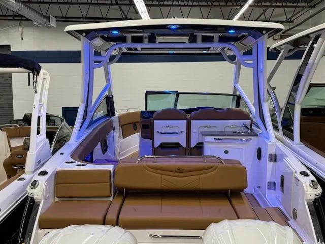 Slide: The Image of 2025 Chaparral 280 OSX boat interior with brown seating and modern design. - 26