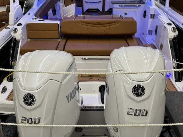 Slide: The Image of 2025 Chaparral 280 OSX boat with dual Yamaha 200 engines, brown seating, and modern interior. - 27