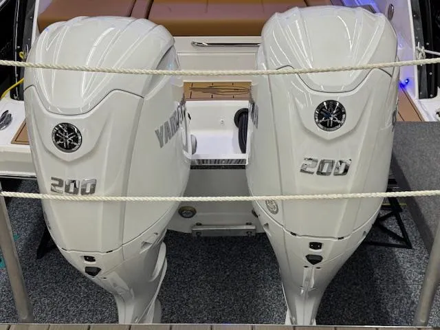 Slide: The Image of 2025 Chaparral 280 OSX with twin 200 horsepower outboard engines, rear view. - 28