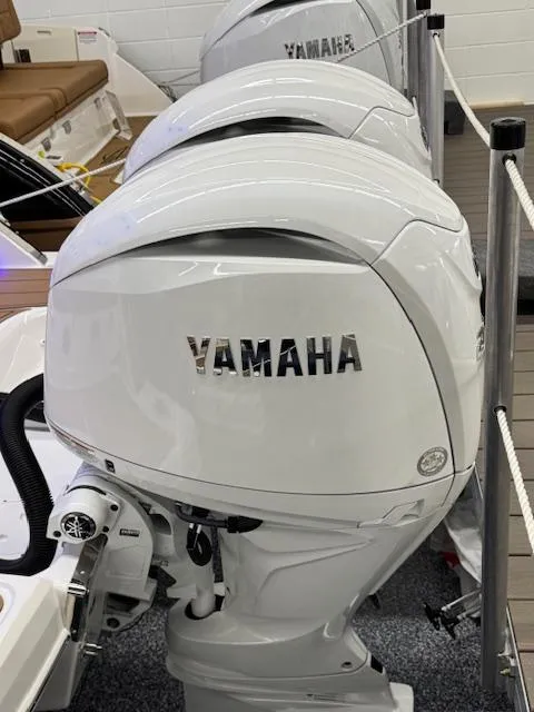 Slide: The Image of 2025 Chaparral 280 OSX with Yamaha outboard engines, showcased in a showroom. - 29