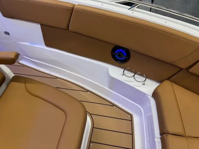 Slide: The Image of 2025 Chaparral 280 OSX boat interior with brown seating and cup holders. - 5