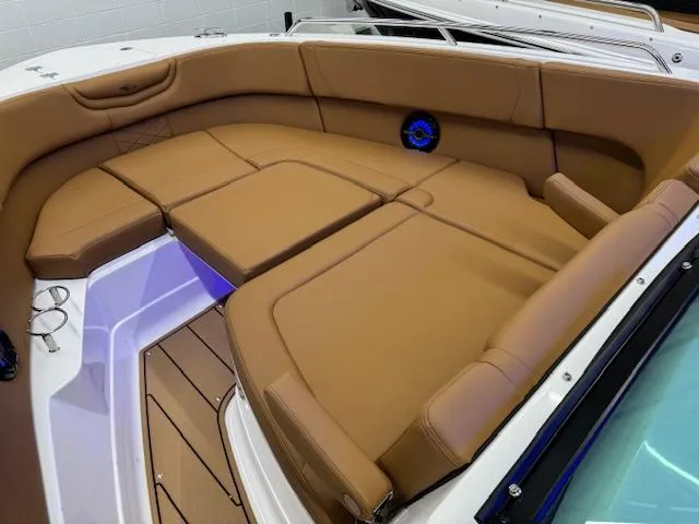 Slide: The Image of 2025 Chaparral 280 OSX boat interior with tan seating and modern design. - 6