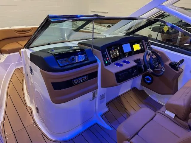 Slide: The Image of 2025 Chaparral 280 OSX boat interior with modern dashboard and seating. - 8
