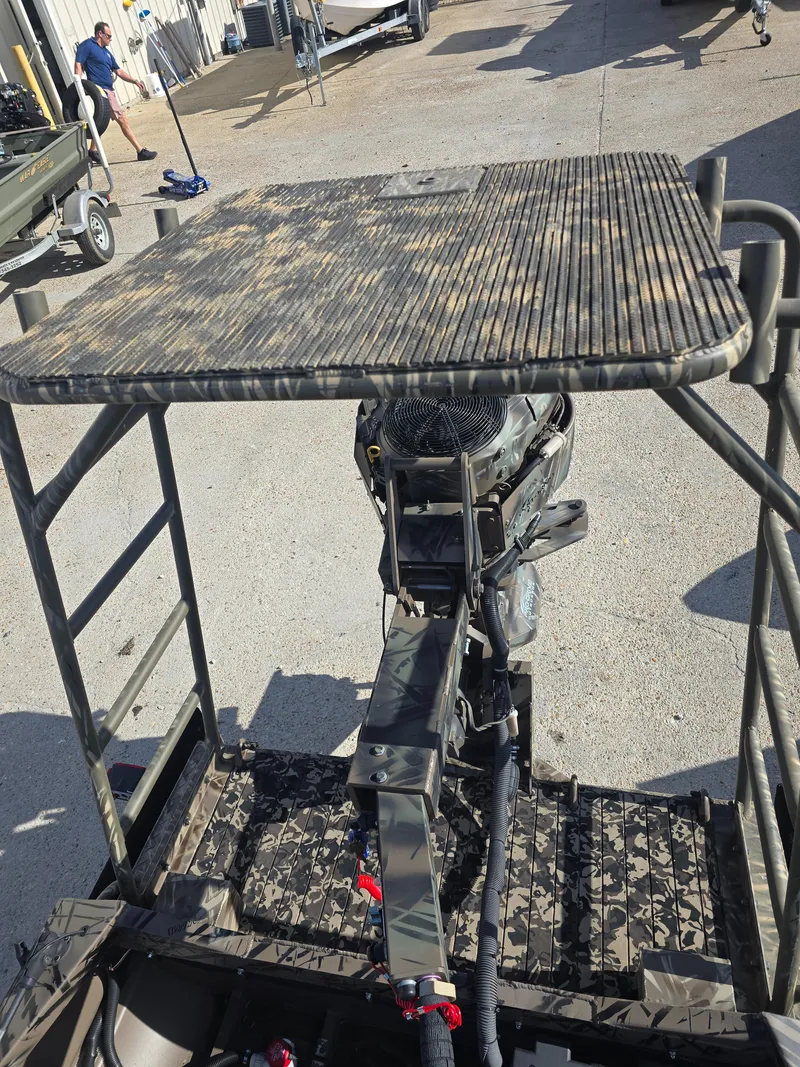 Slide: The Image of 2006 Pro-Drive 1748 boat with camouflage deck and motor, parked outdoors. - 10