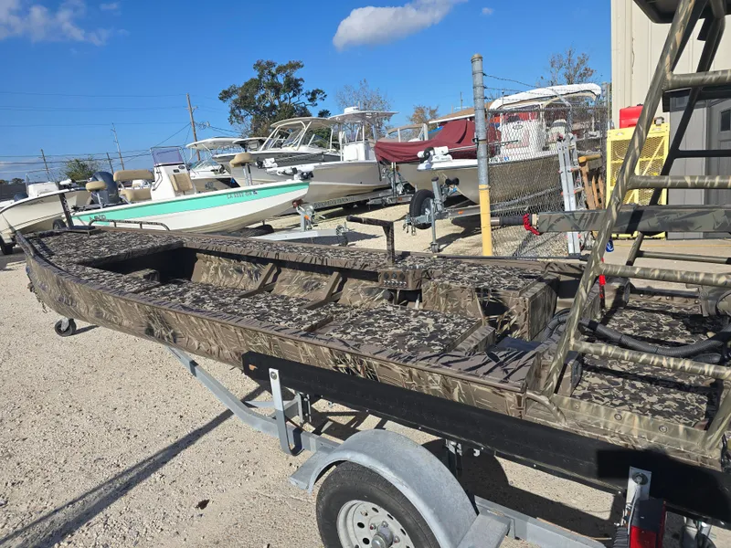 Slide: The Image of 2006 Pro-Drive 1748 boat on trailer, camouflage design, parked outdoors. - 2