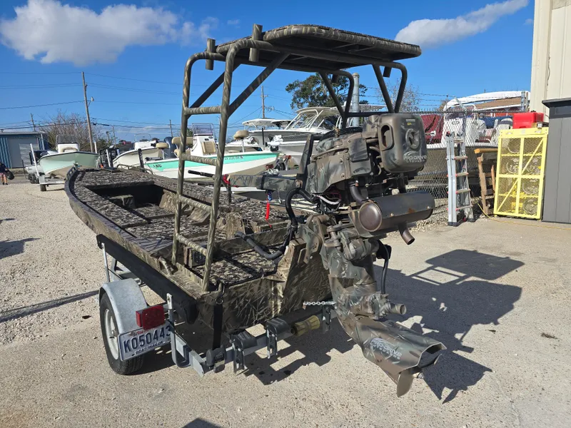Slide: The Image of 2006 Pro-Drive 1748 boat with camouflage design on a trailer in a boatyard. - 3