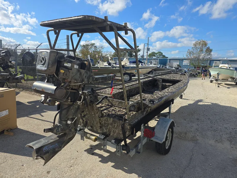 Slide: The Image of 2006 Pro-Drive 1748 boat on trailer, camo design, outdoor setting, clear sky. - 4