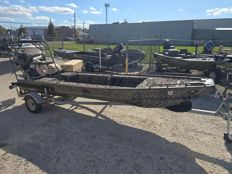 Slide: The Image of 2006 Pro-Drive 1748 boat on trailer, parked outdoors under clear sky. - 5