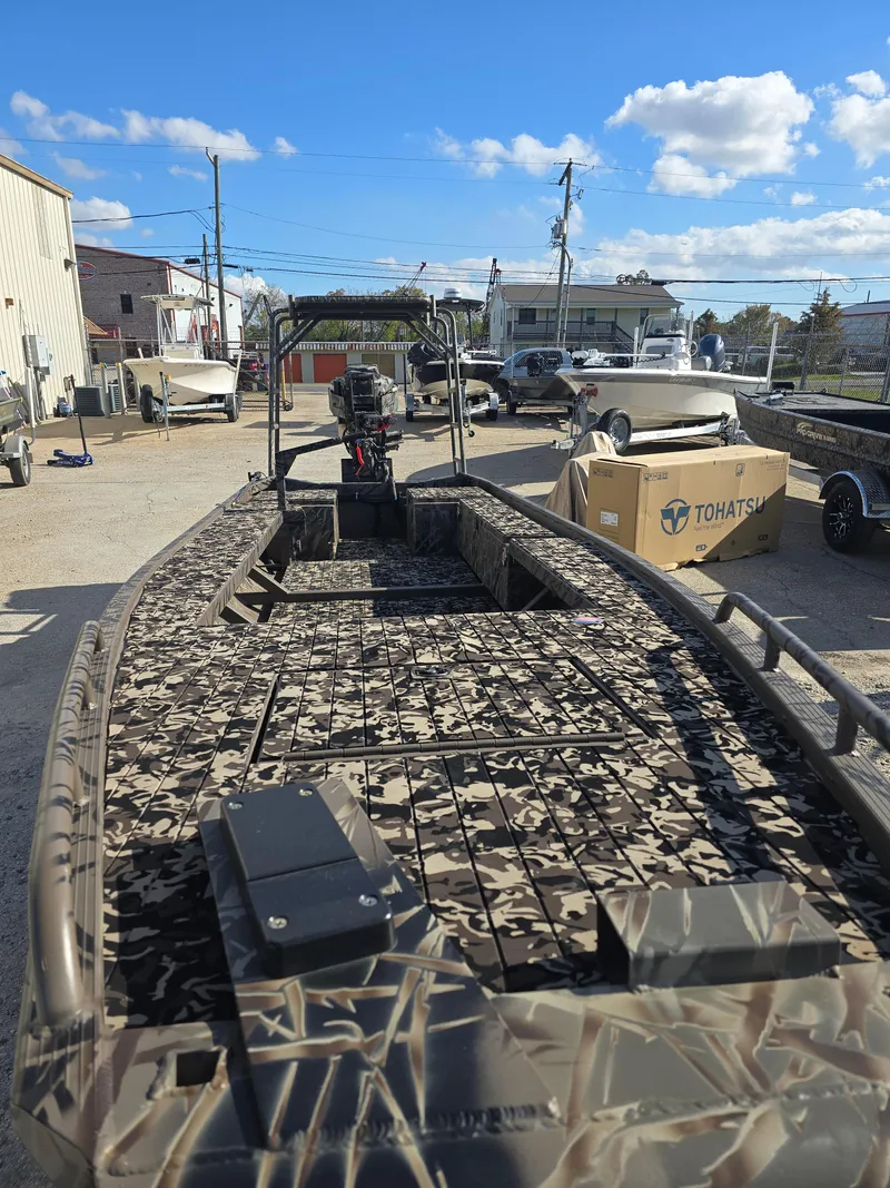 Slide: The Image of 2006 Pro-Drive 1748 boat with camouflage design, parked outdoors under a clear sky. - 8