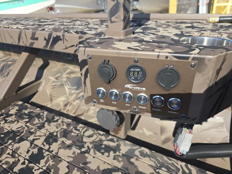 Slide: The Image of Control panel of 2006 Pro-Drive 1748 boat with camouflage design and voltage display. - 9