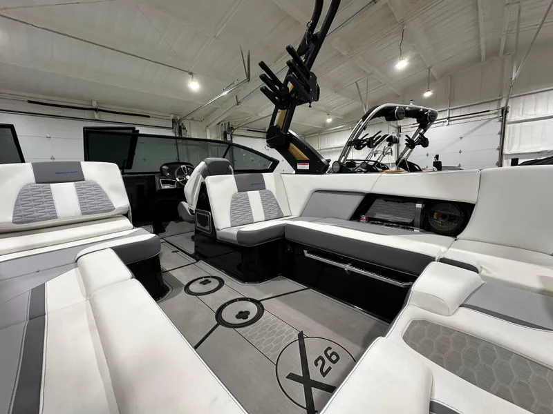 Slide: The Image of 2024 MasterCraft X26 boat interior with luxurious seating and modern design. - 11