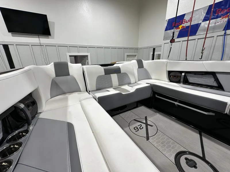 Slide: The Image of 2024 MasterCraft X26 boat interior with sleek white and gray seating. - 12