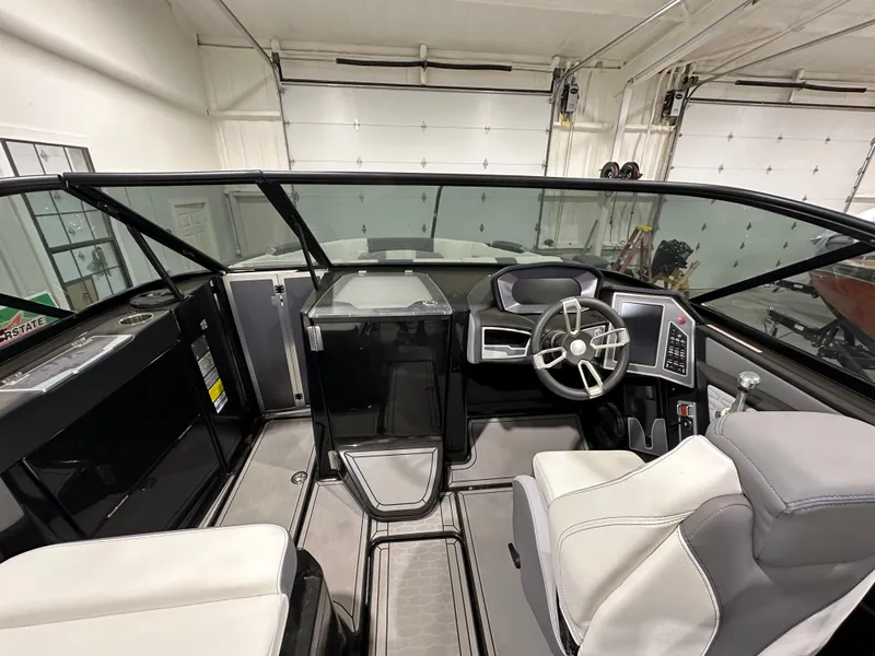 Slide: The Image of 2024 MasterCraft X26 boat interior with modern dashboard and seating. - 16