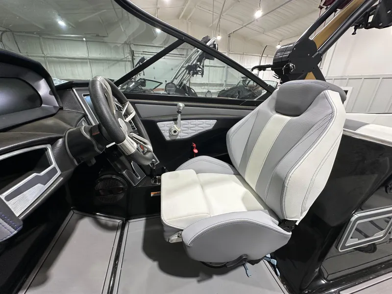 Slide: The Image of 2024 MasterCraft X26 boat interior with modern steering and comfortable seating. - 18