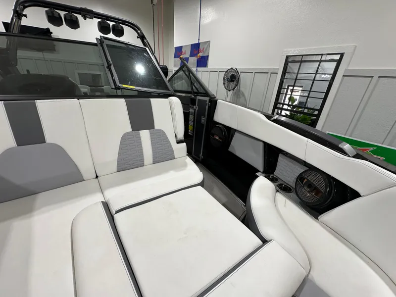 Slide: The Image of 2024 MasterCraft X26 boat interior with white and gray seating, modern design. - 19