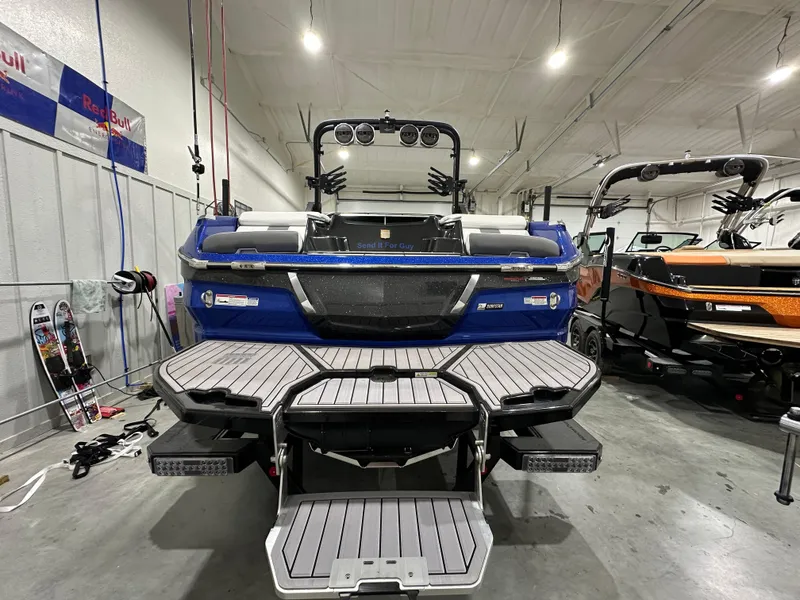 Slide: The Image of 2024 MasterCraft X26 boat in showroom, featuring sleek design and modern amenities. - 2