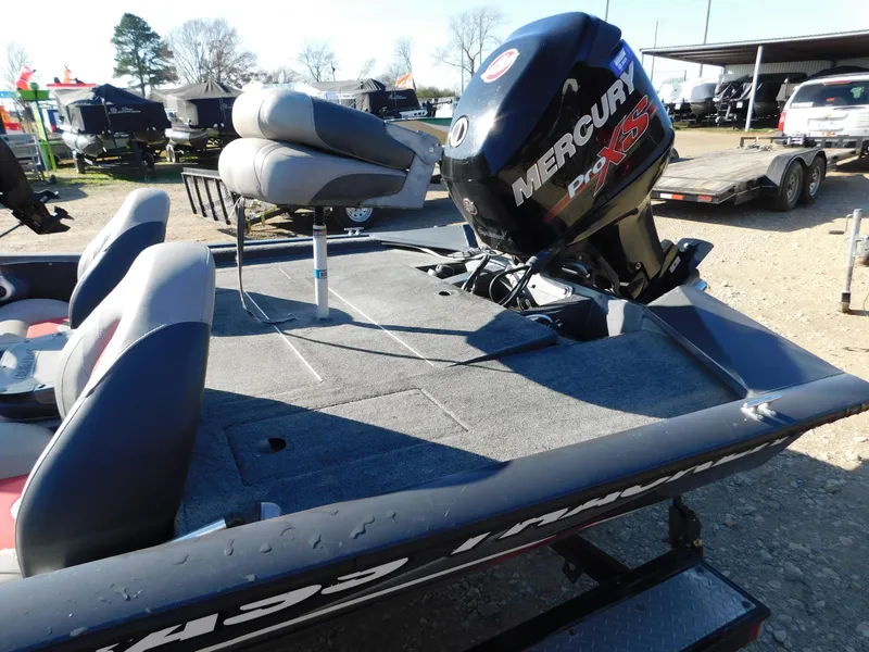 Slide: The Image of 2015 Tracker Pro Team 190 TX boat with Mercury engine, parked outdoors. - 14