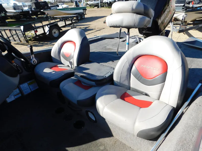 Slide: The Image of 2015 Tracker Pro Team 190 TX boat interior with gray and red seating. - 15