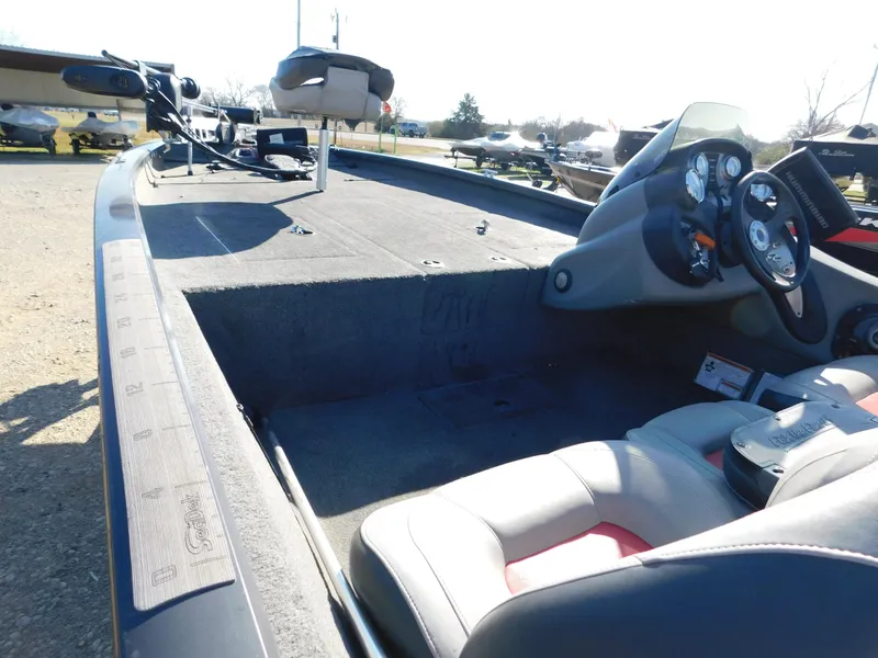 Slide: The Image of 2015 Tracker Pro Team 190 TX boat interior with steering console and seating. - 17
