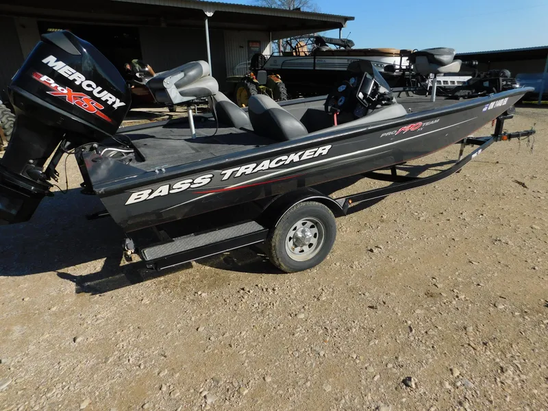Slide: The Image of 2015 Tracker Pro Team 190 TX bass boat with Mercury engine on trailer. - 2