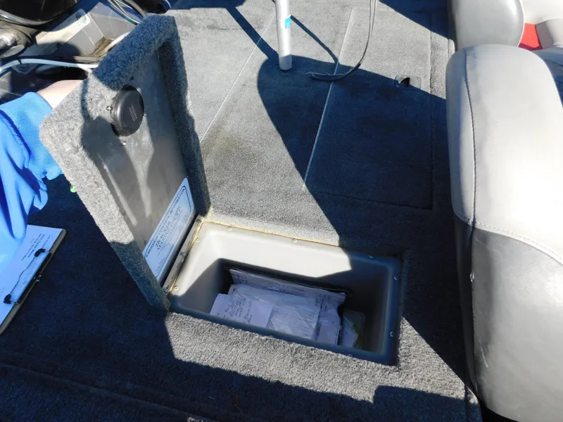 Slide: The Image of Open storage compartment in 2015 Tracker Pro Team 190 TX boat interior. - 23