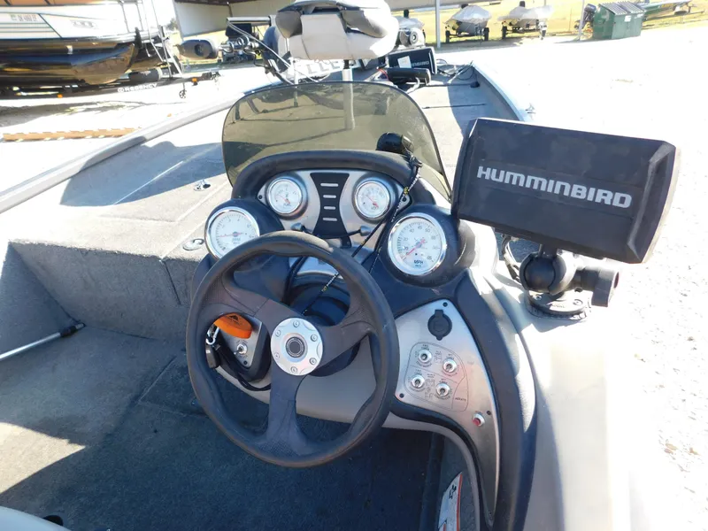 Slide: The Image of 2015 Tracker Pro Team 190 TX boat dashboard with steering wheel and Humminbird fish finder. - 25