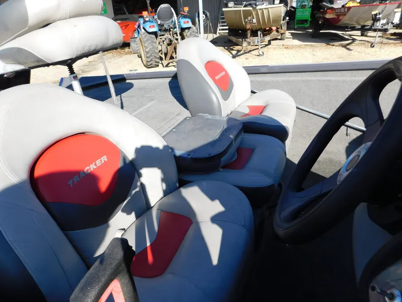 Slide: The Image of 2015 Tracker Pro Team 190 TX boat interior with gray and red seating. - 26