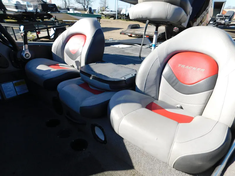 Slide: The Image of 2015 Tracker Pro Team 190 TX boat interior with gray and red seats. - 39