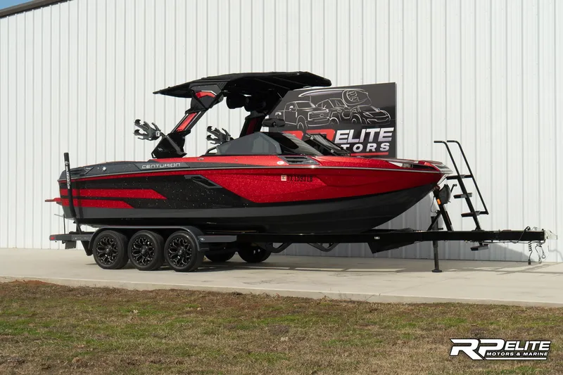 Slide: The Image of 2024 Centurion Ri245 boat in red and black on a trailer at RP Elite Motors. - 10