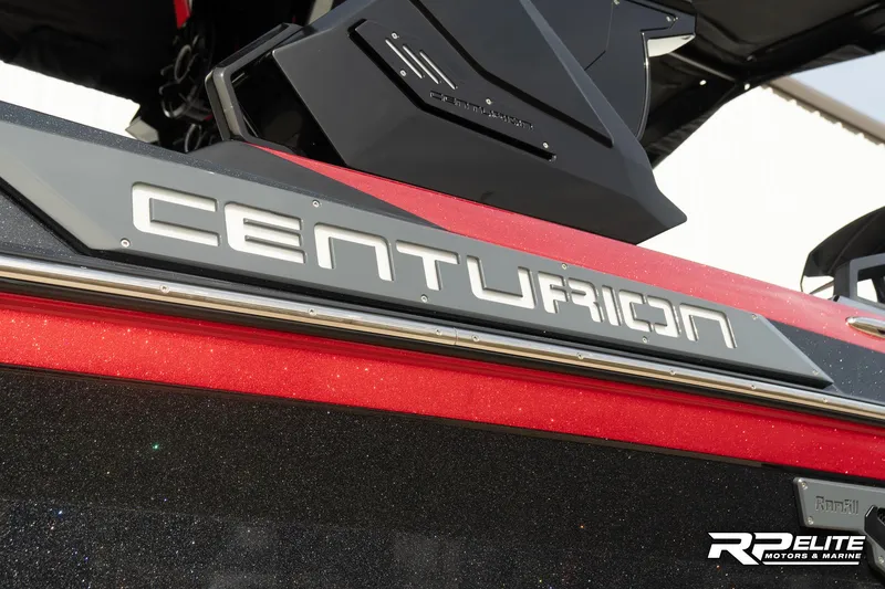 Slide: The Image of 2024 Centurion Ri245 boat, red and black exterior, close-up of logo. - 20