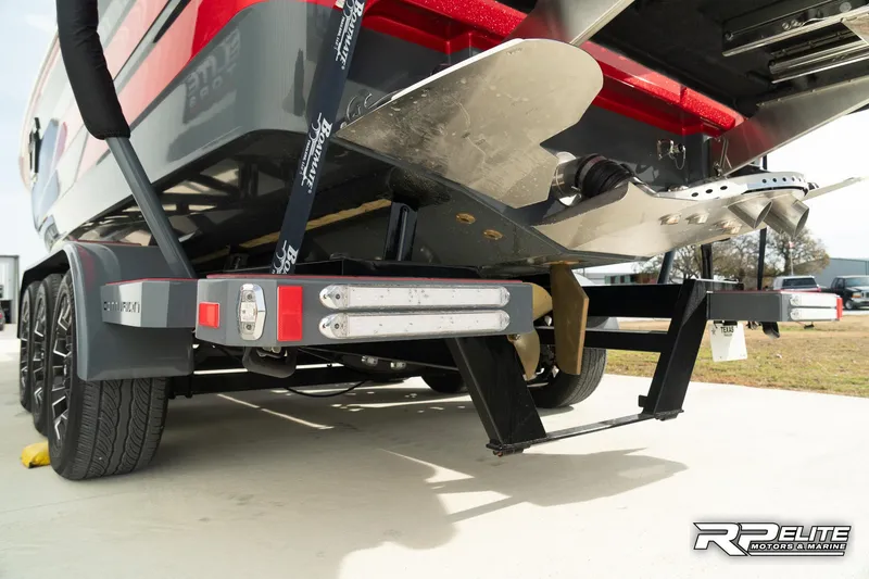 Slide: The Image of 2024 Centurion Ri245 boat on trailer, showcasing rear design and propeller. - 33