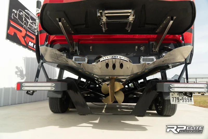 Slide: The Image of 2024 Centurion Ri245 boat rear view with propeller and trailer. - 37