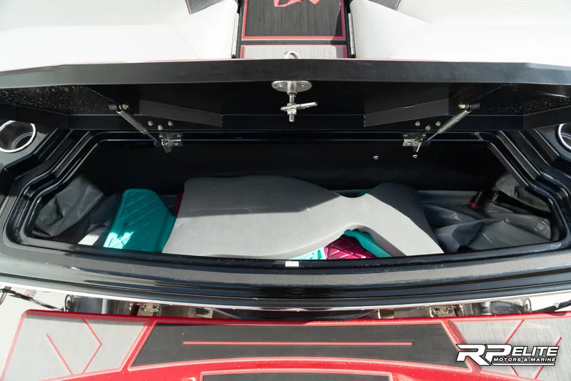 Slide: The Image of 2024 Centurion Ri245 boat storage compartment with colorful interior padding. - 49