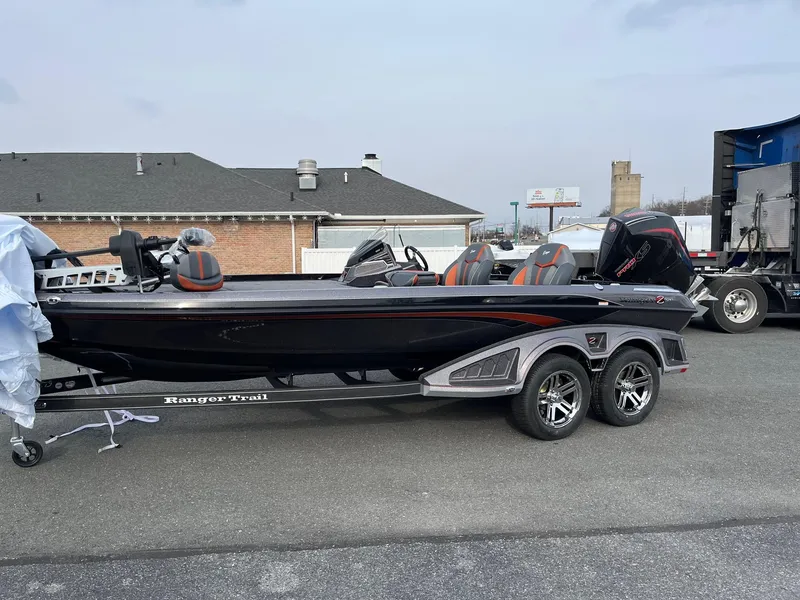 The Image of 2025 Ranger Z520 boat on trailer, parked outdoors, featuring sleek black design and modern seating. - 0