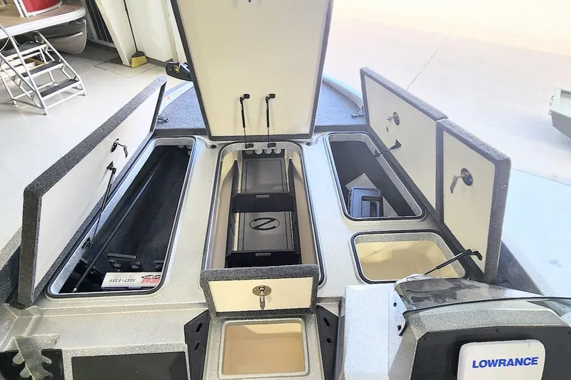 Slide: The Image of 2025 Ranger Z185 boat storage compartments with open lids, featuring Lowrance electronics. - 5