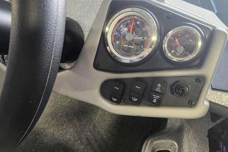 Slide: The Image of Dashboard of 2025 Ranger Z185 boat with gauges and control switches. - 9