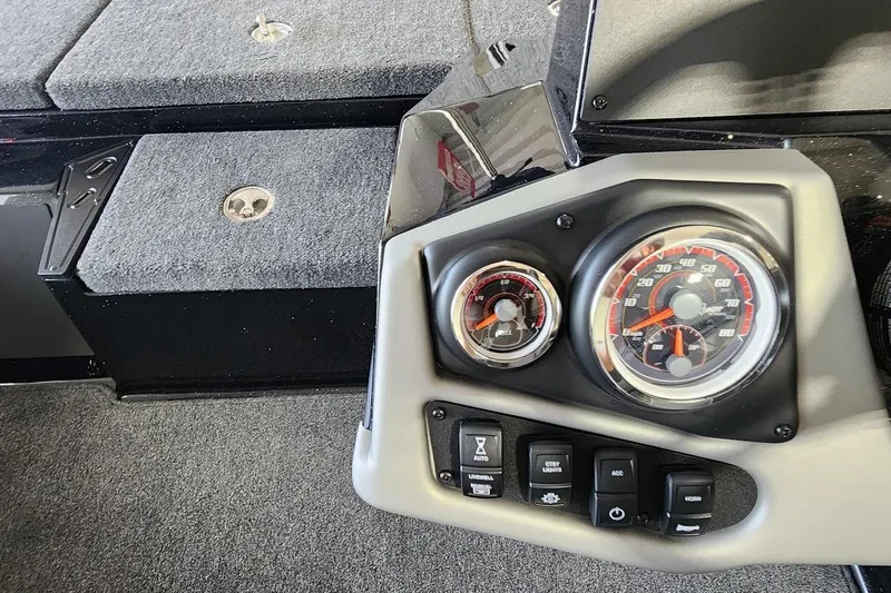 Slide: The Image of Dashboard of 2025 Ranger Z185 boat with gauges and control switches. - 10