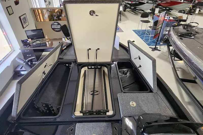 Slide: The Image of 2025 Ranger Z185 boat interior with open storage compartments in showroom. - 4
