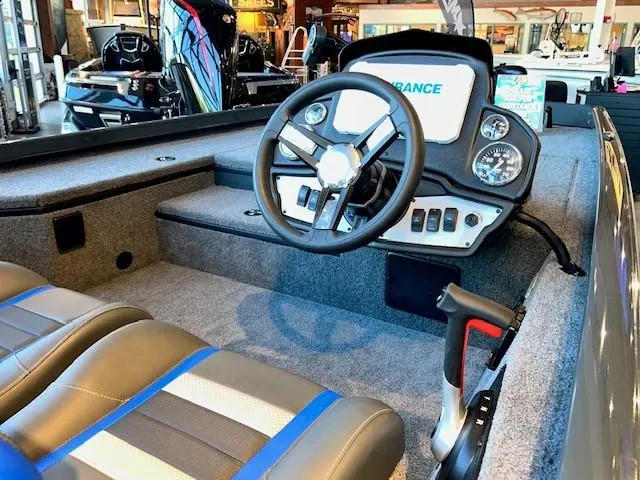 Slide: The Image of 2025 Ranger RT178 boat interior with steering wheel and dashboard controls. - 2