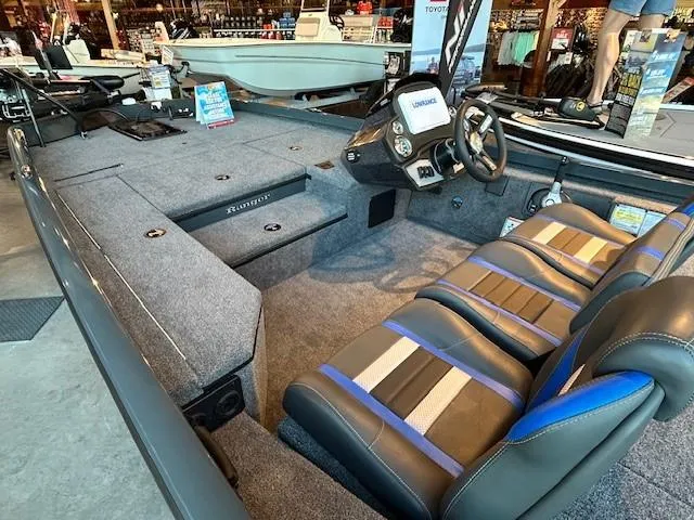 Slide: The Image of 2025 Ranger RT178 boat interior with modern seating and control panel in showroom. - 3