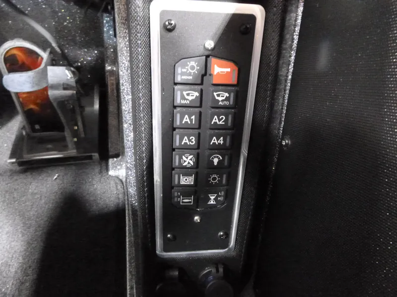 Slide: The Image of Control panel of a 2025 Ranger Z520 boat with various function buttons. - 10