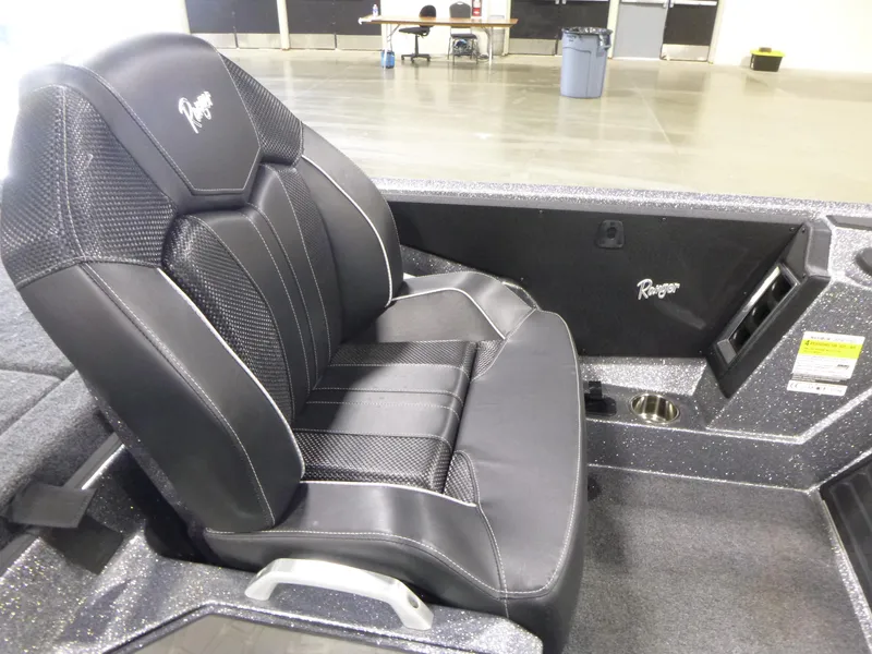 Slide: The Image of 2025 Ranger Z520 boat seat, black leather with stitching, in a showroom setting. - 12