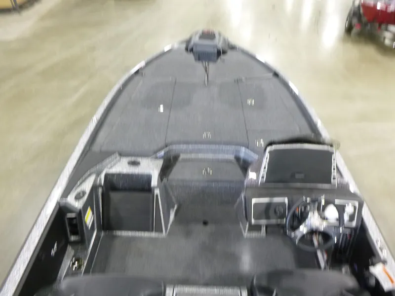 Slide: The Image of 2025 Ranger Z520 boat interior with steering console and seating. - 14