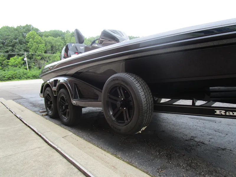 Slide: The Image of 2025 Ranger Z520 boat on trailer with black wheels, parked outdoors. - 3