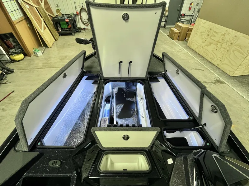 Slide: The Image of Interior of 2025 Ranger Z520 boat with blue and gray seating and storage compartment. - 13